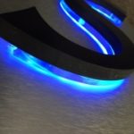 Closeup of neon letter S with blue neon