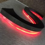 Closeup of neon letter S with red neon