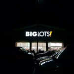 BigLots Storefront at night with neon logo sign on building