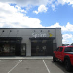 Sprint storefront with large logo sign and red truck parked outside