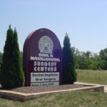 Rounded sign next to road for Oral & Maxillofacial Surgery Centers location in central Ohio