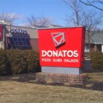 Logo sign in foreground of Donato's Pizza restaurant in Central Ohio