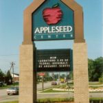 Appleseed Center shopping center sign next to road